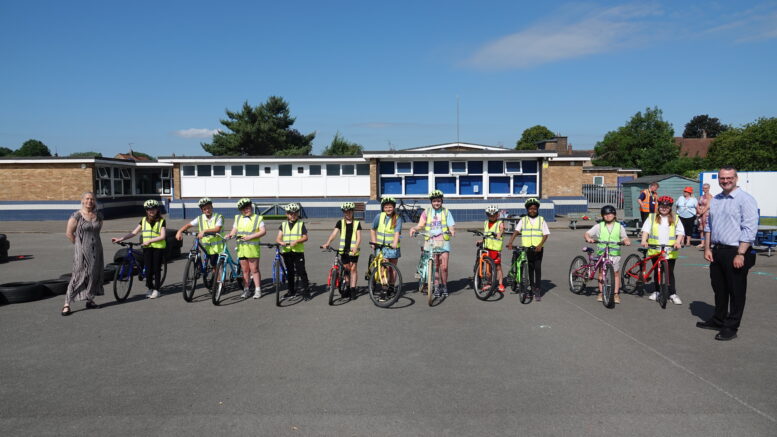 Children at Rokeby Park Primary School during a Bikeability training session with Councillor Tracey Henry (left) and Councillor Mark Ieronimo (right)