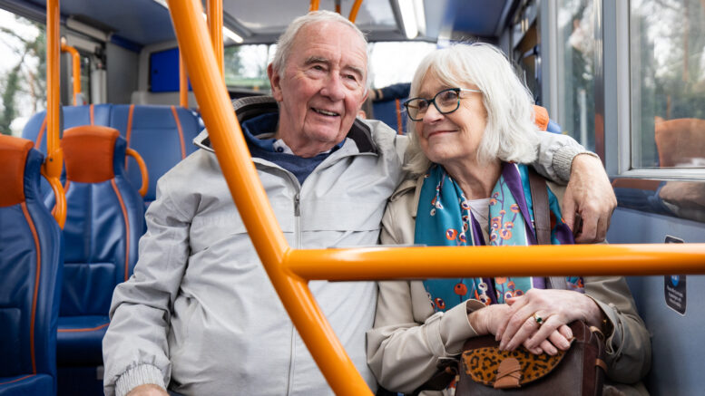 An older couple riding a bus