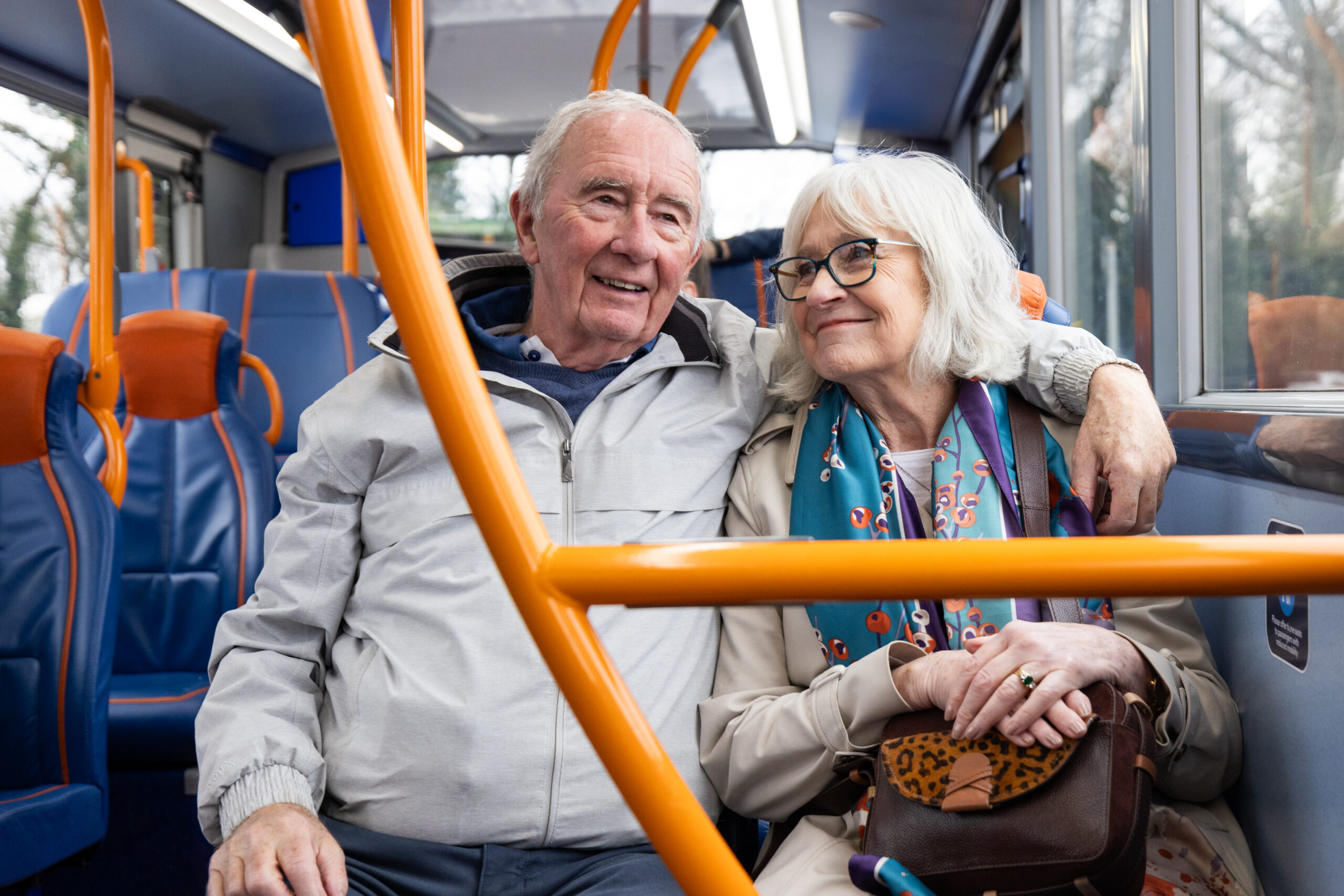 An older couple riding a bus