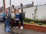 Maria Pearce (far right), and local residents and volunteers stood in-front of the community garden.