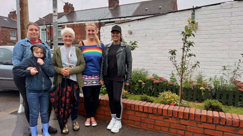 Maria Pearce (far right), and local residents and volunteers stood in-front of the community garden.
