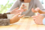 Three friends hands talking in a bar