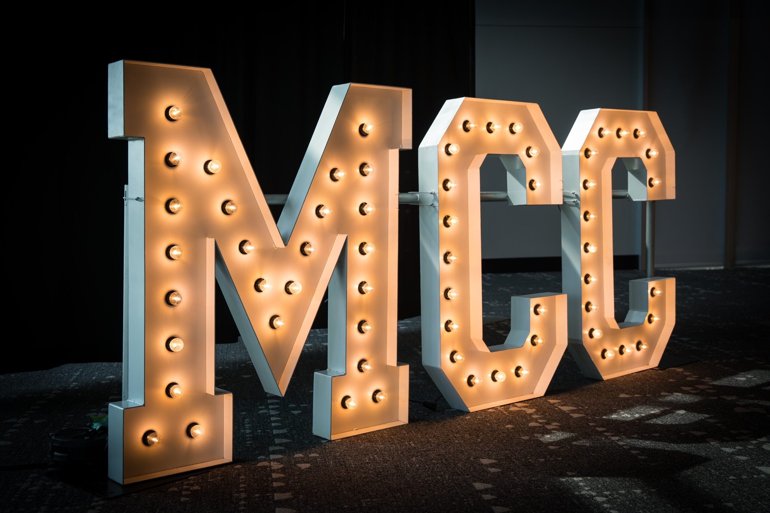 Large light up letters spelling MCC