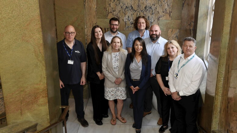 Multiply partners on internal guildhall staircase.