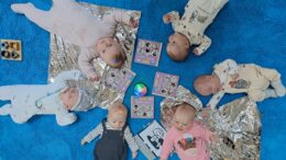 Six babies laid in a circle