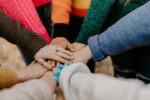 The hands of a group of people together