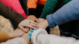 The hands of a group of people together