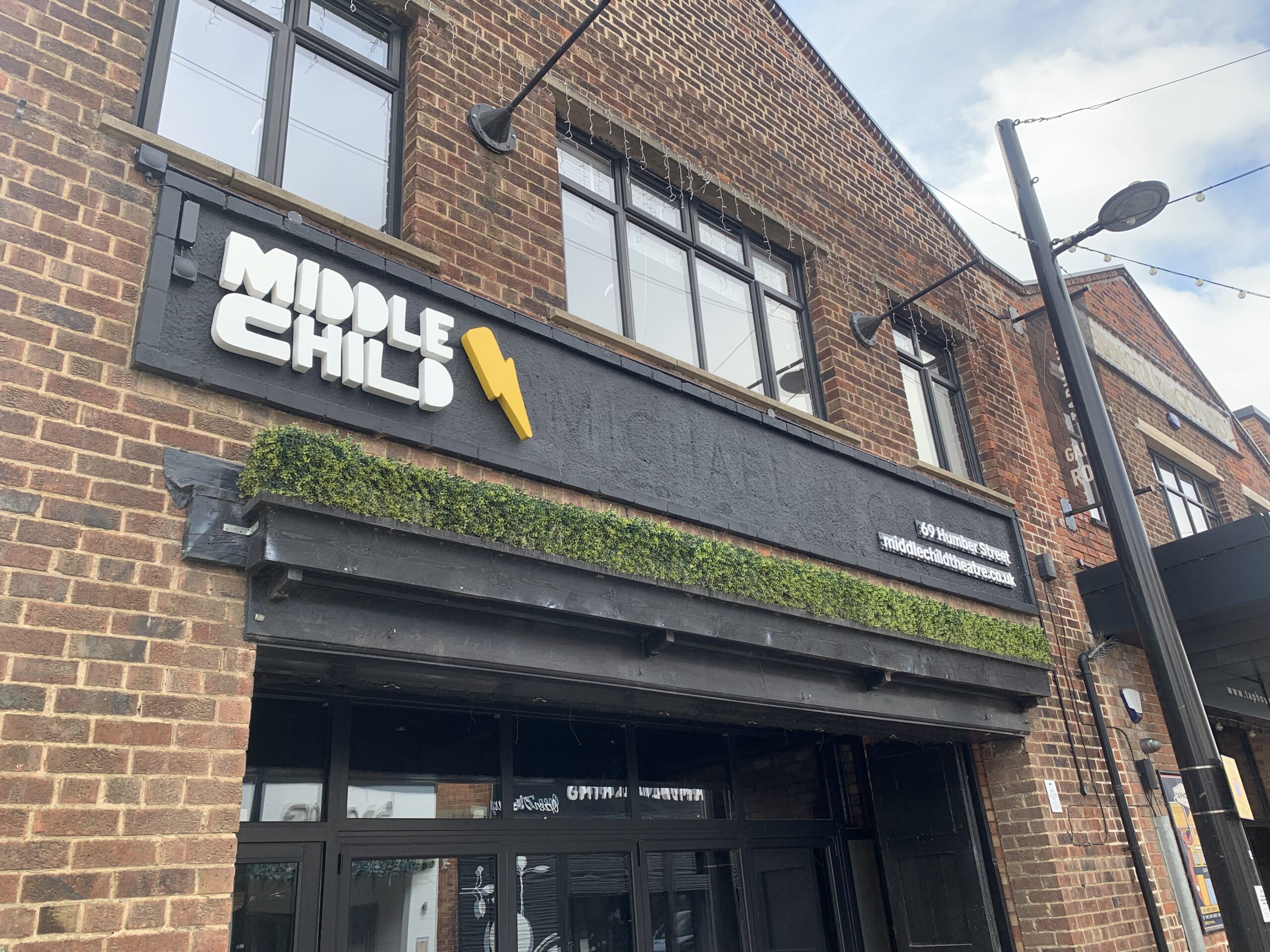 A close up of Middle Child theatre's sign on its theatre on Humber Street.