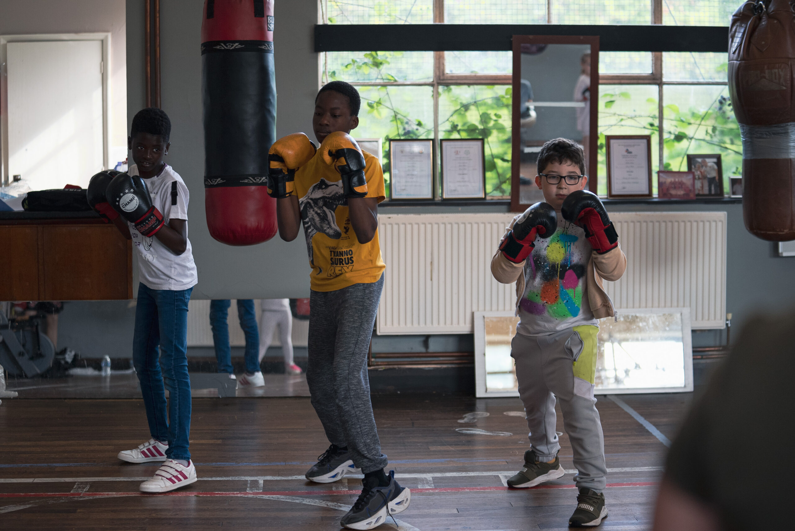 three children take part in a boxing activity at a previous Healthy Holidays session