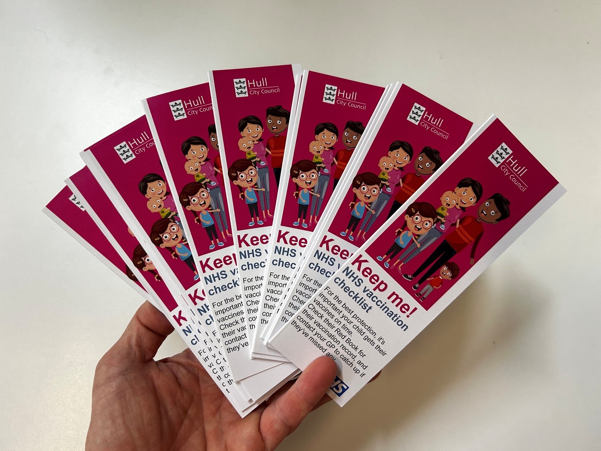 a hand holds a number of the bookmarks