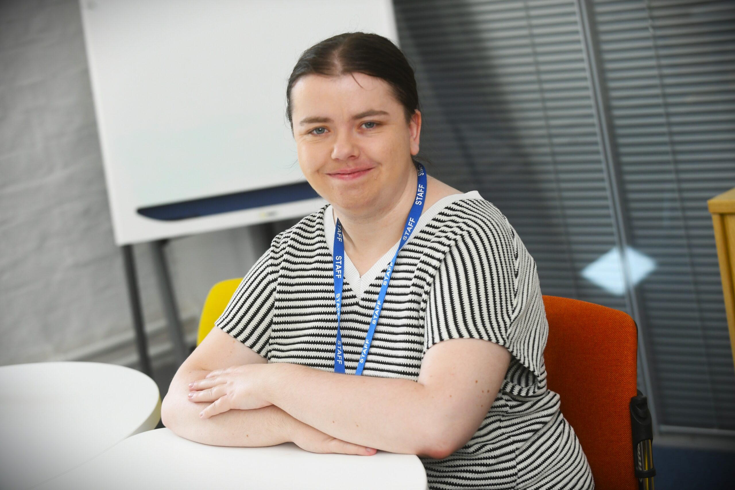 Amy Shepherd - BA3 distinction apprentice, sat at a desk.