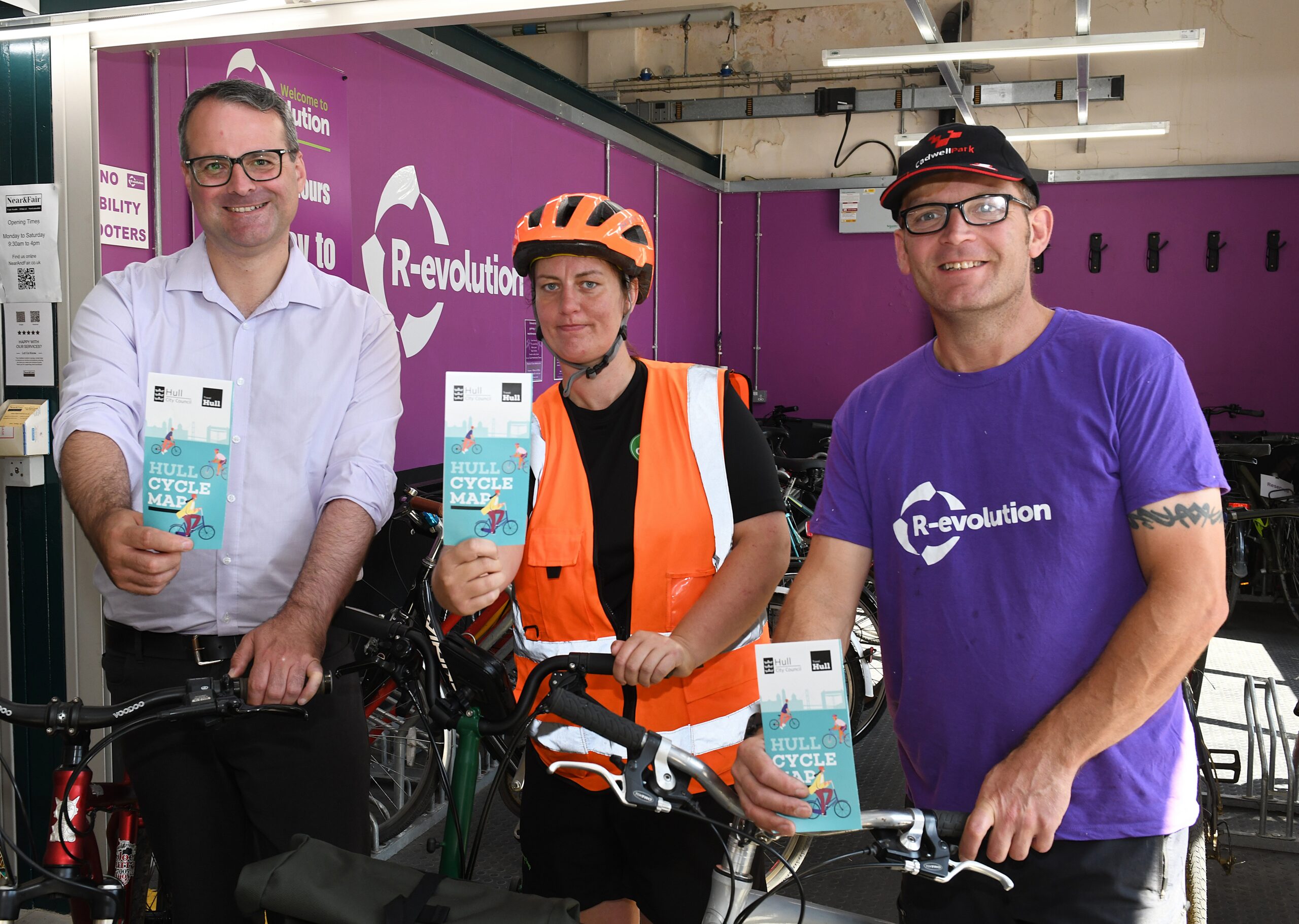 Councillor Mark Ieronimo of Hull City Council, Rebecca Rose from First Step Sports and Barry Steward of R-evolution with copies of the new Hull Cycle Map.