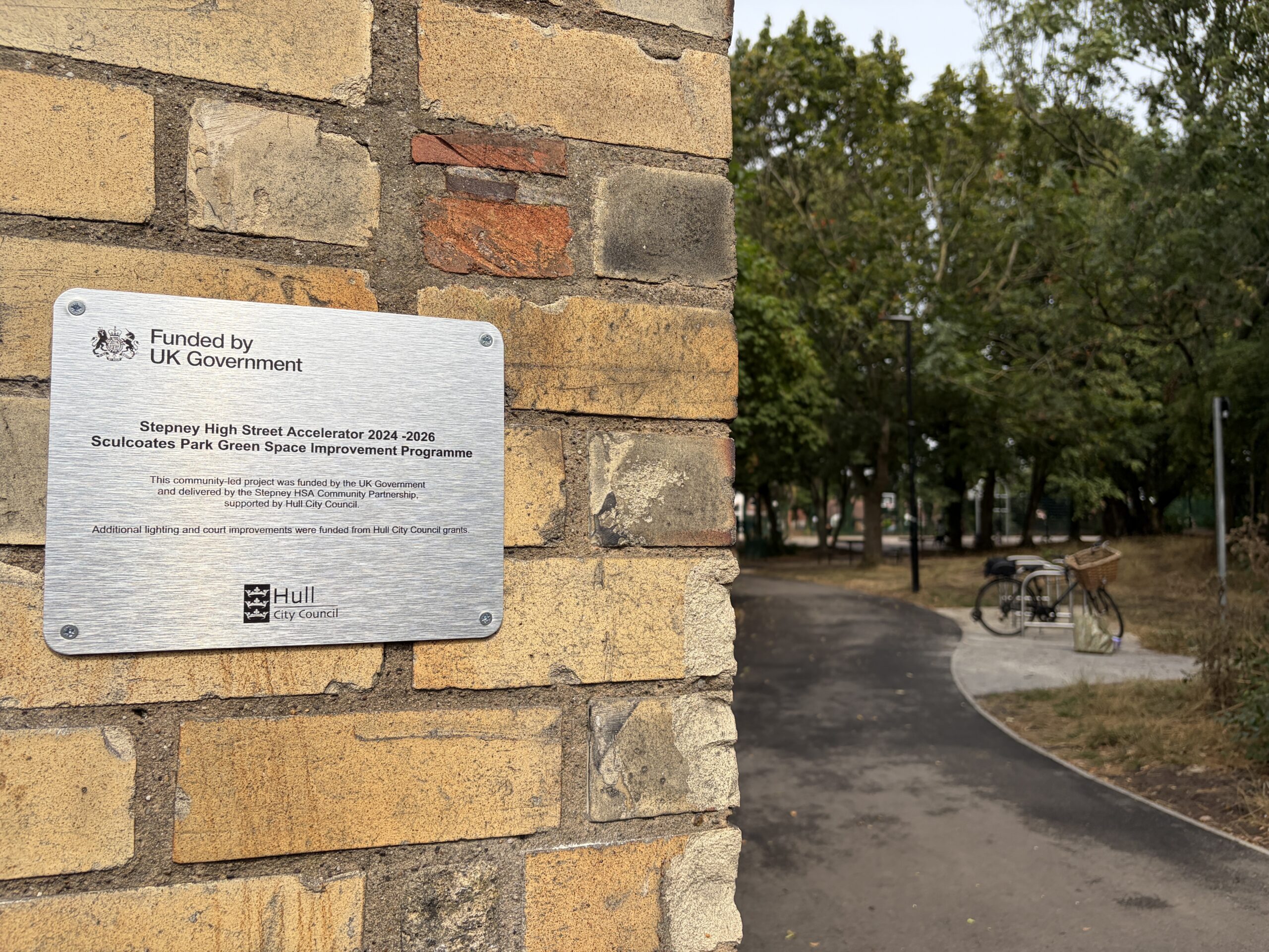A silver plaque on the brick pillar was revealed to mark the formal reopening of Sculcoates Park.