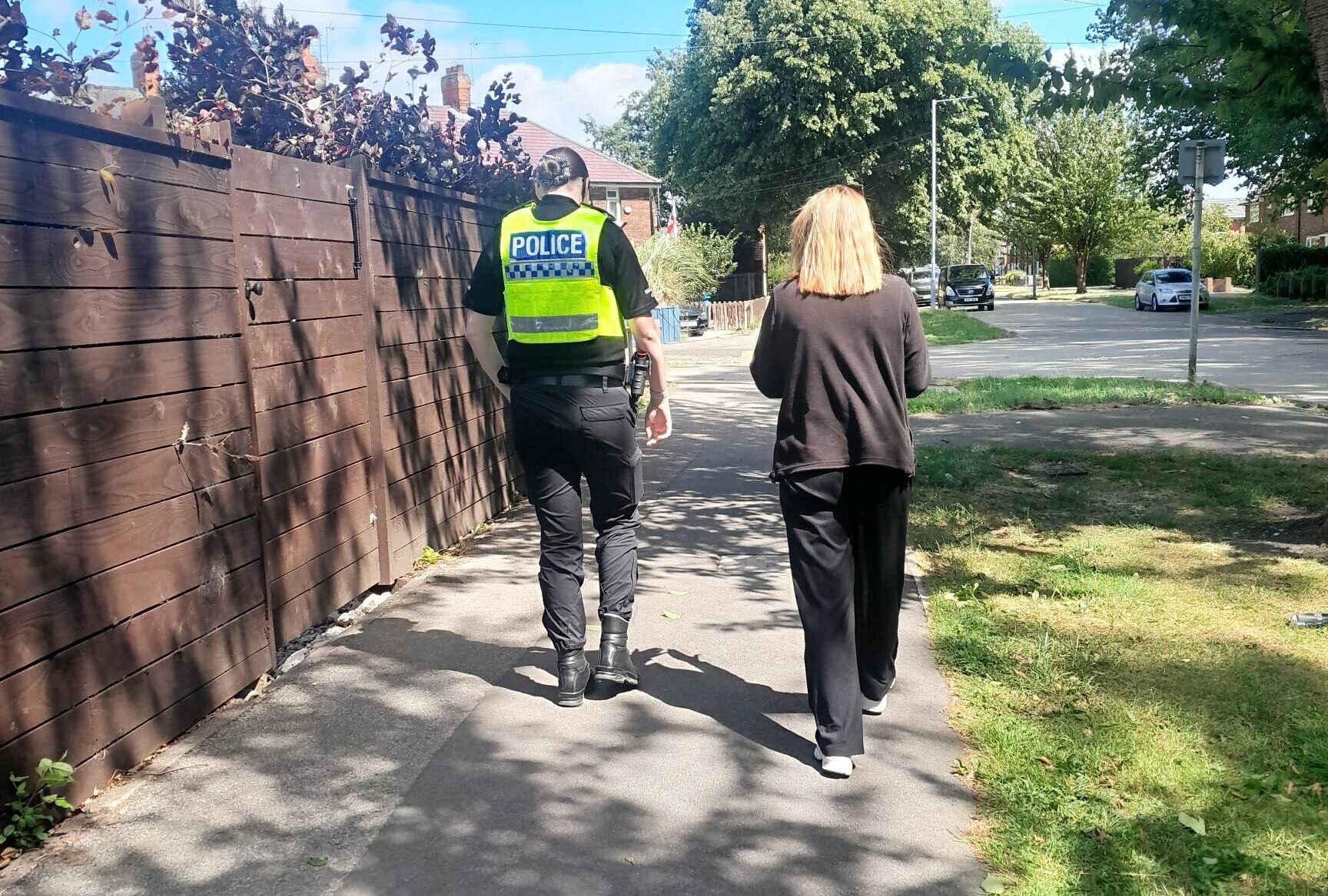 A police officer and a member of the Neighbourhood Nuisance Team visit a community to look out for problems
