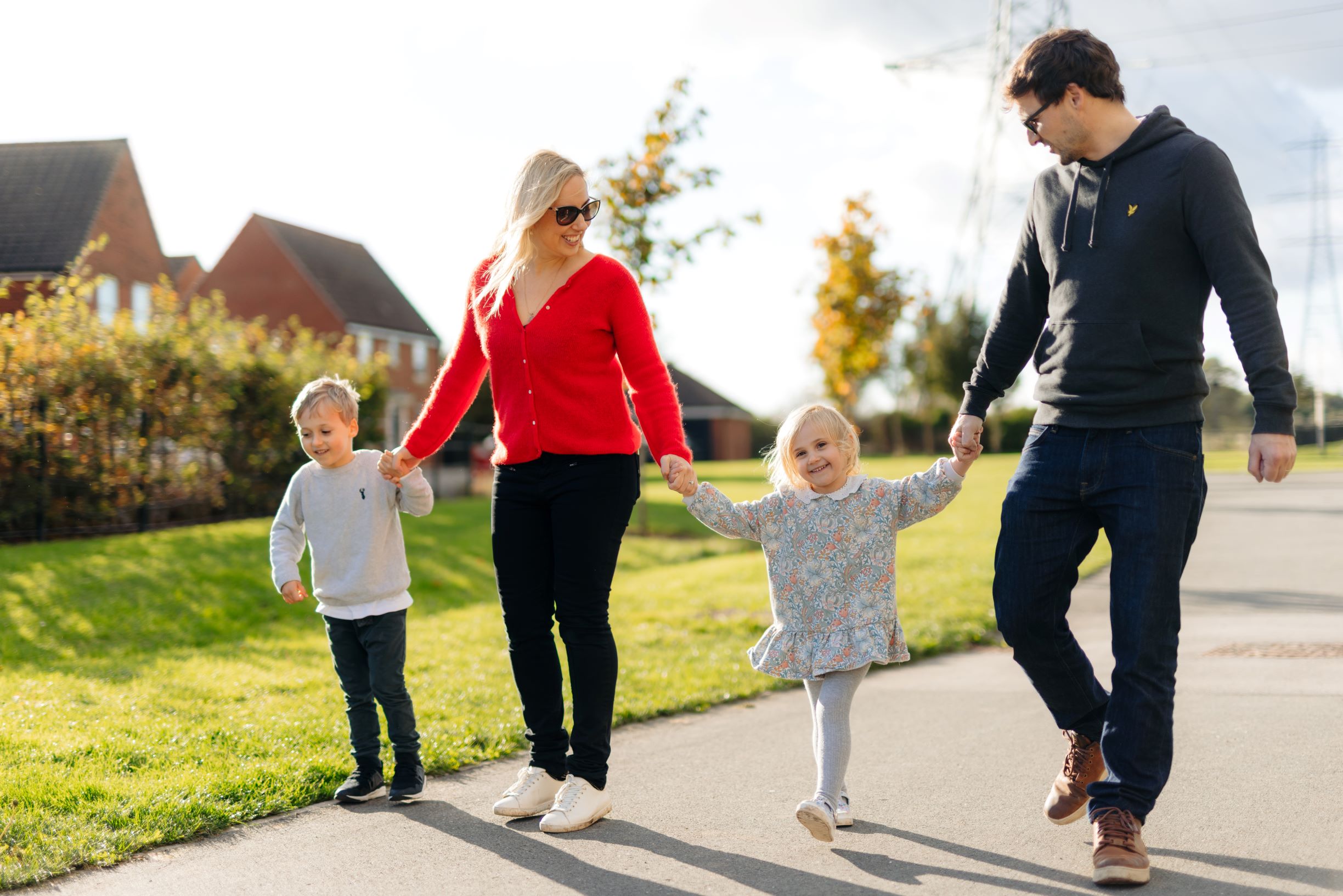A young family walking hand-in-hand in Kingswood, Hull.