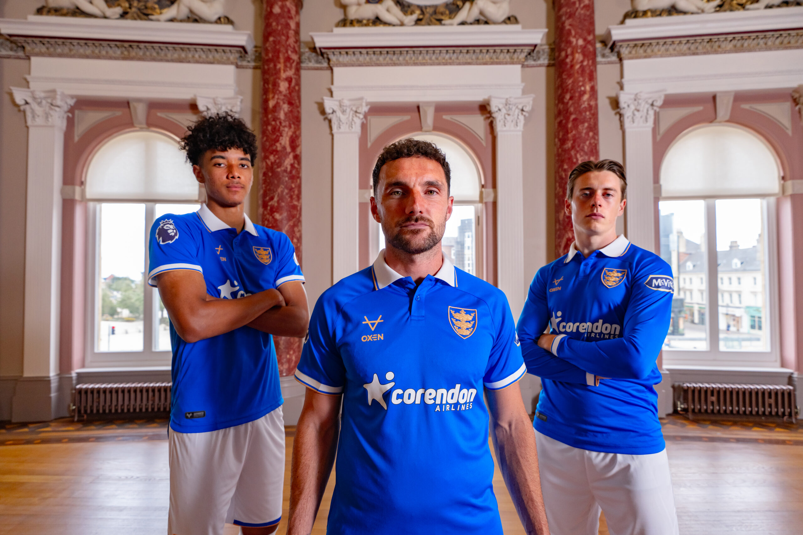 Hull City captain Lewie Coyle, inside the Maritime Museum, flanked by Luca Herrington (left) and Elliot Stroud (right) in the club's new third kit adorning Hull's armorial bearings having been granted use by the council.