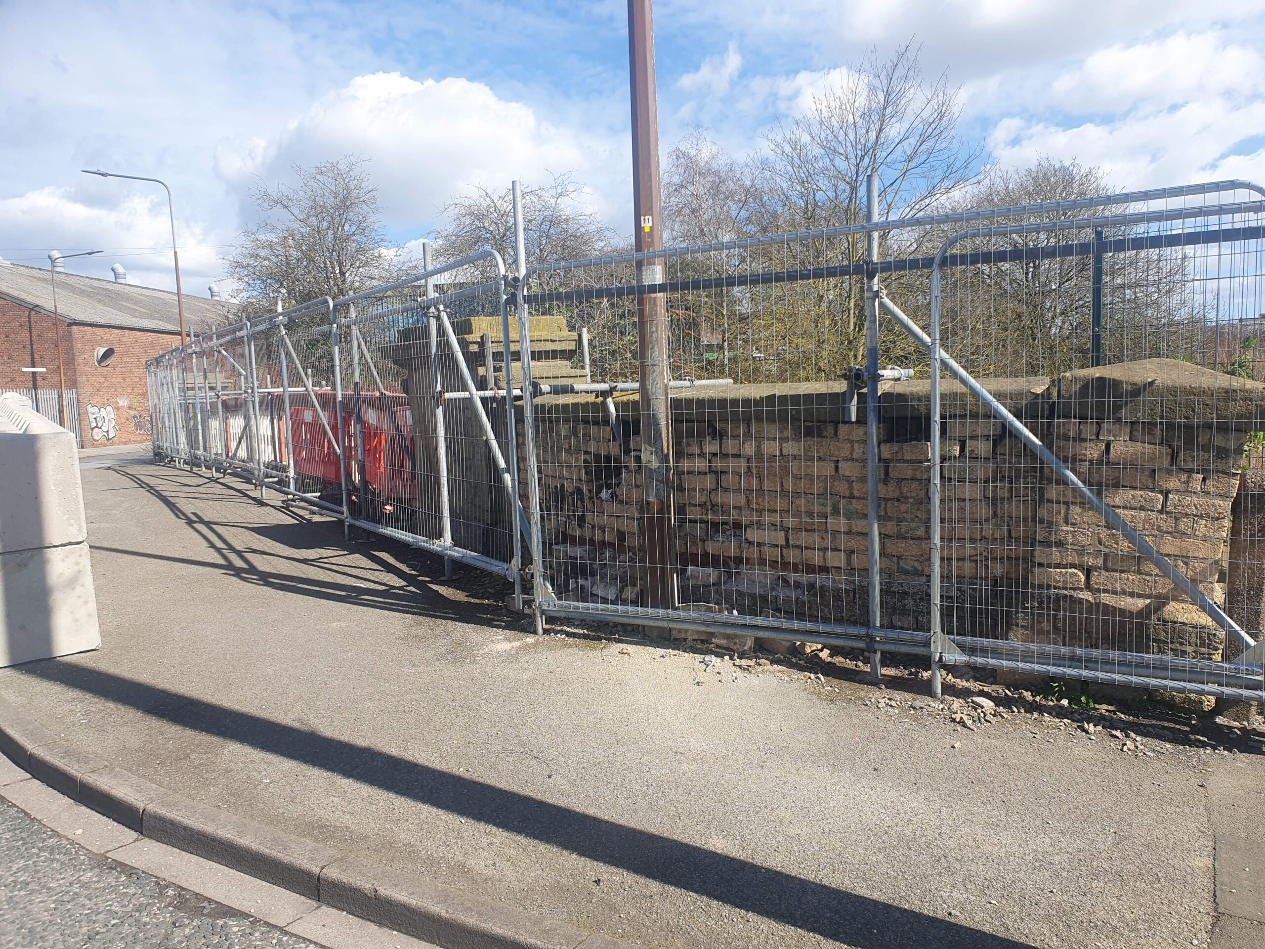 Image shows the southern parapet at Lockwood Street Bridge, which is currently being supported by temporary scaffolding.