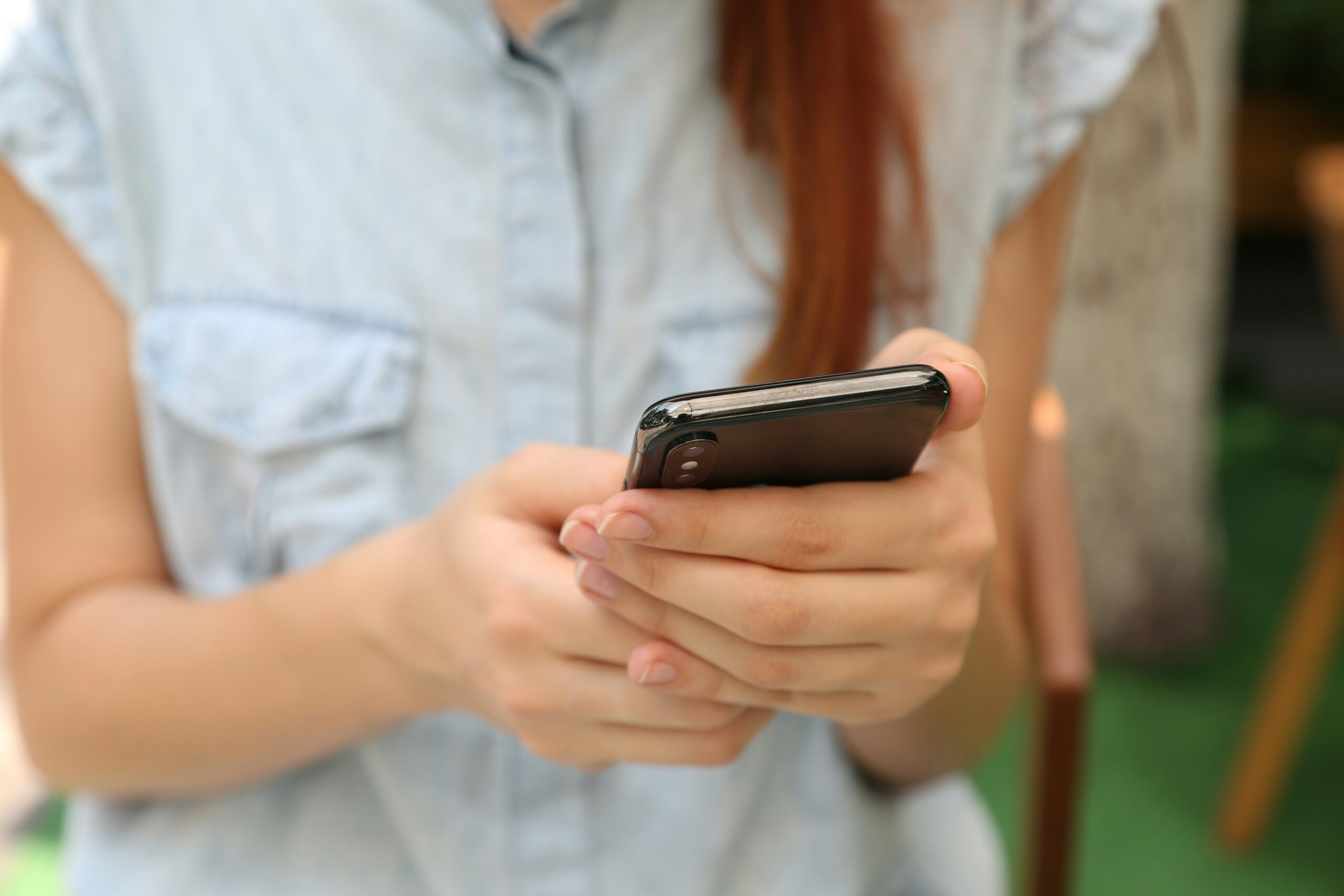 A person holds a phone to send a message